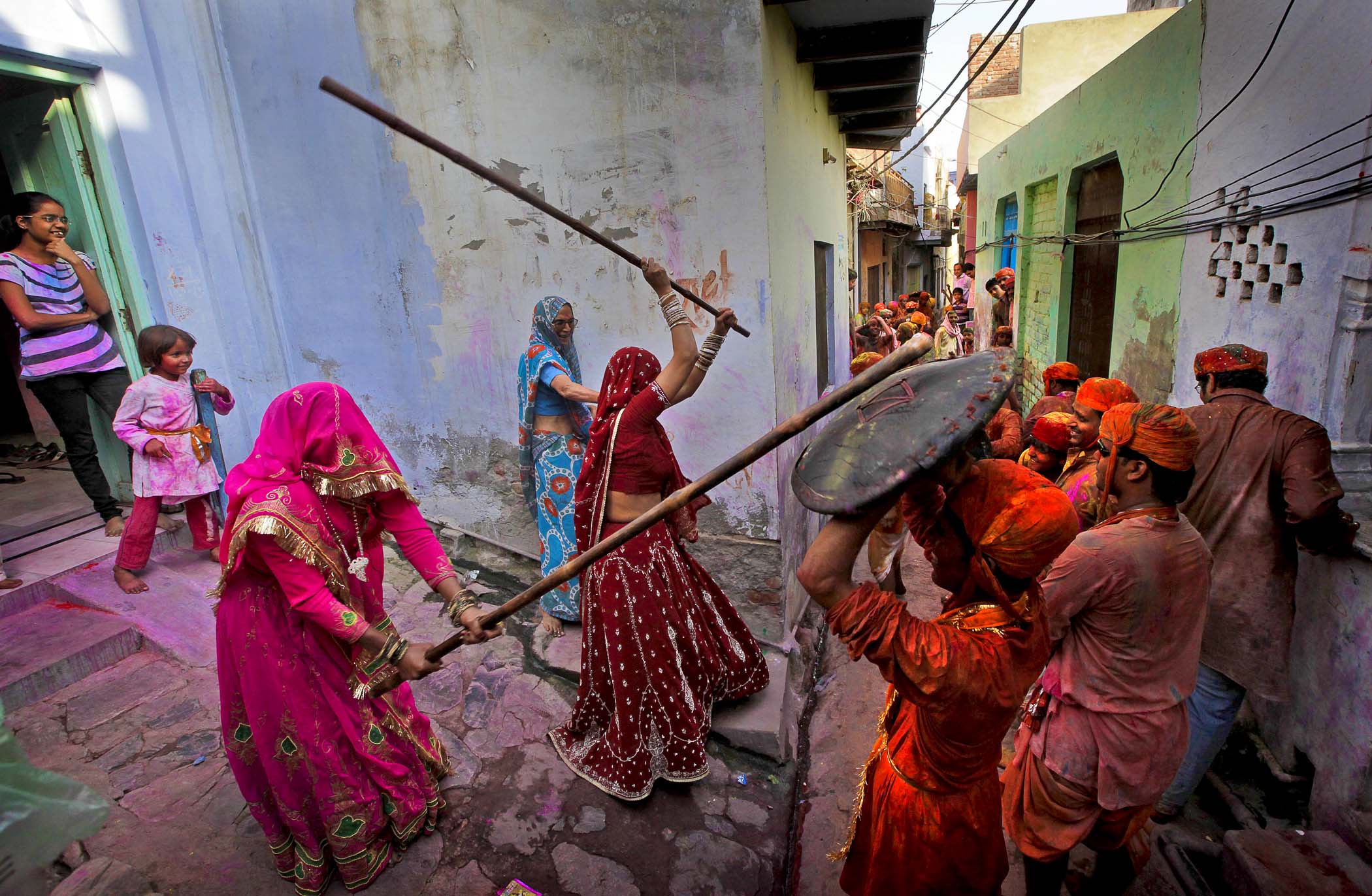 Women from the village of Barsana hit villagers from Nandgaon with wooden sticks during the Lathmar Holi festival. (Manish Swarup/Associated Press)